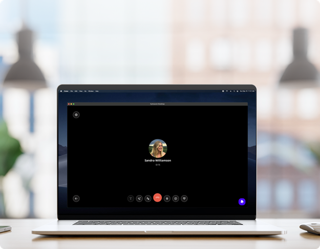 Laptop displaying video call interface with user controls on screen