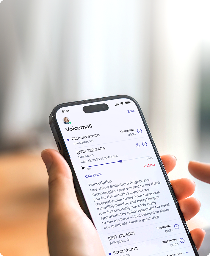 Hand holding smartphone displaying visual voicemail transcription interface
